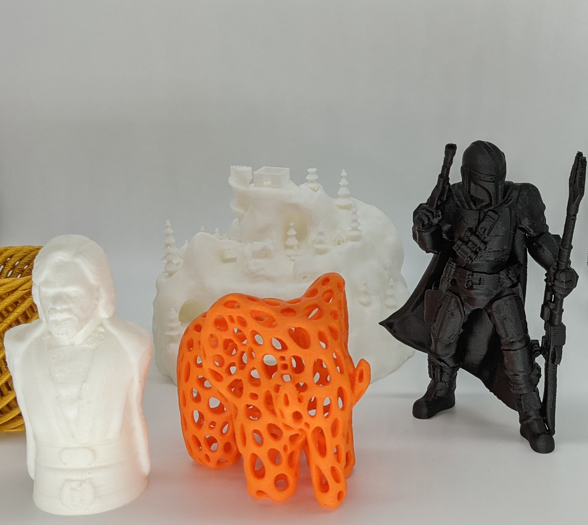 Test prints 3d printed in various PLA filaments, star wars mandalorian, christmas village, luke skywalker, an orange elephant